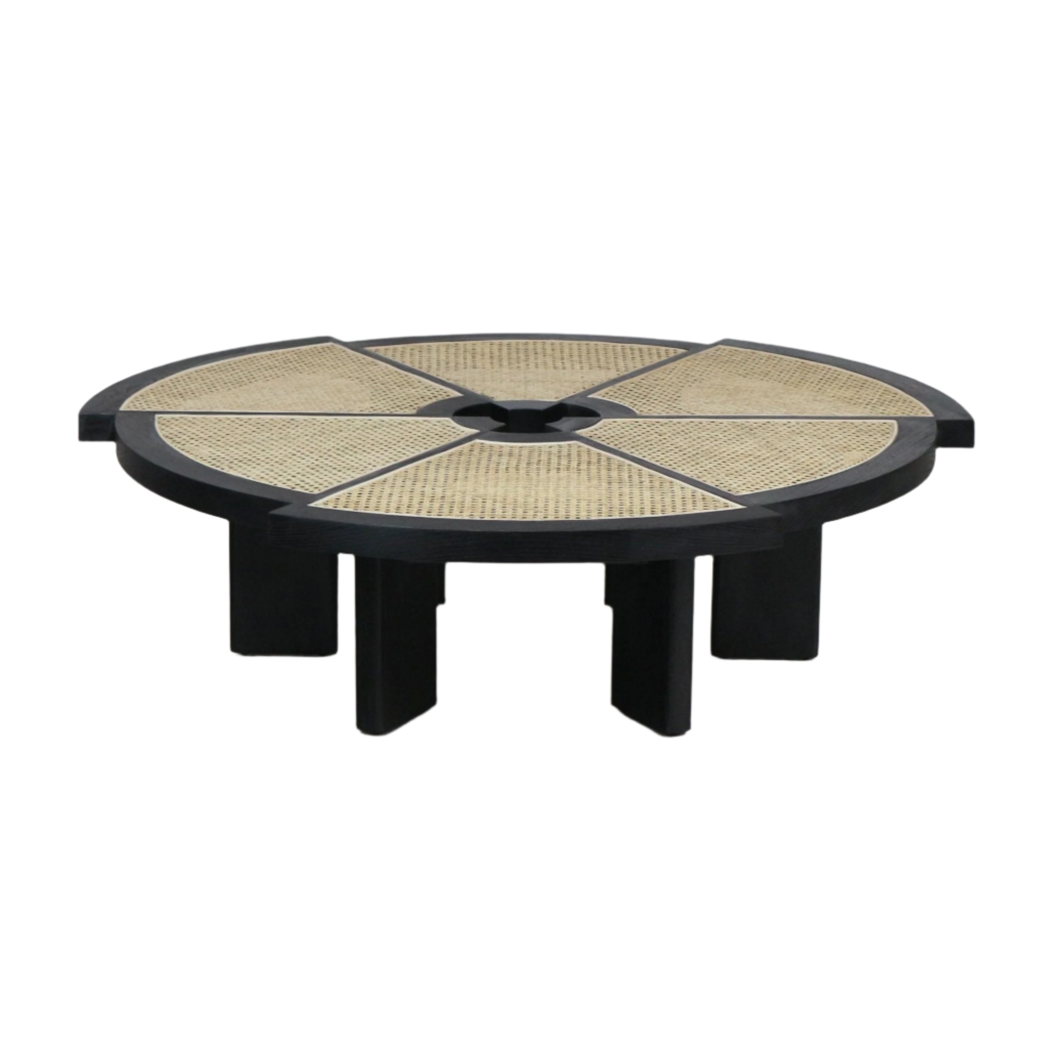 Low-profile round modern coffee table with a black solid-wood frame and six natural cane-woven wedge insets radiating from a central circular opening, supported by thick black block legs.