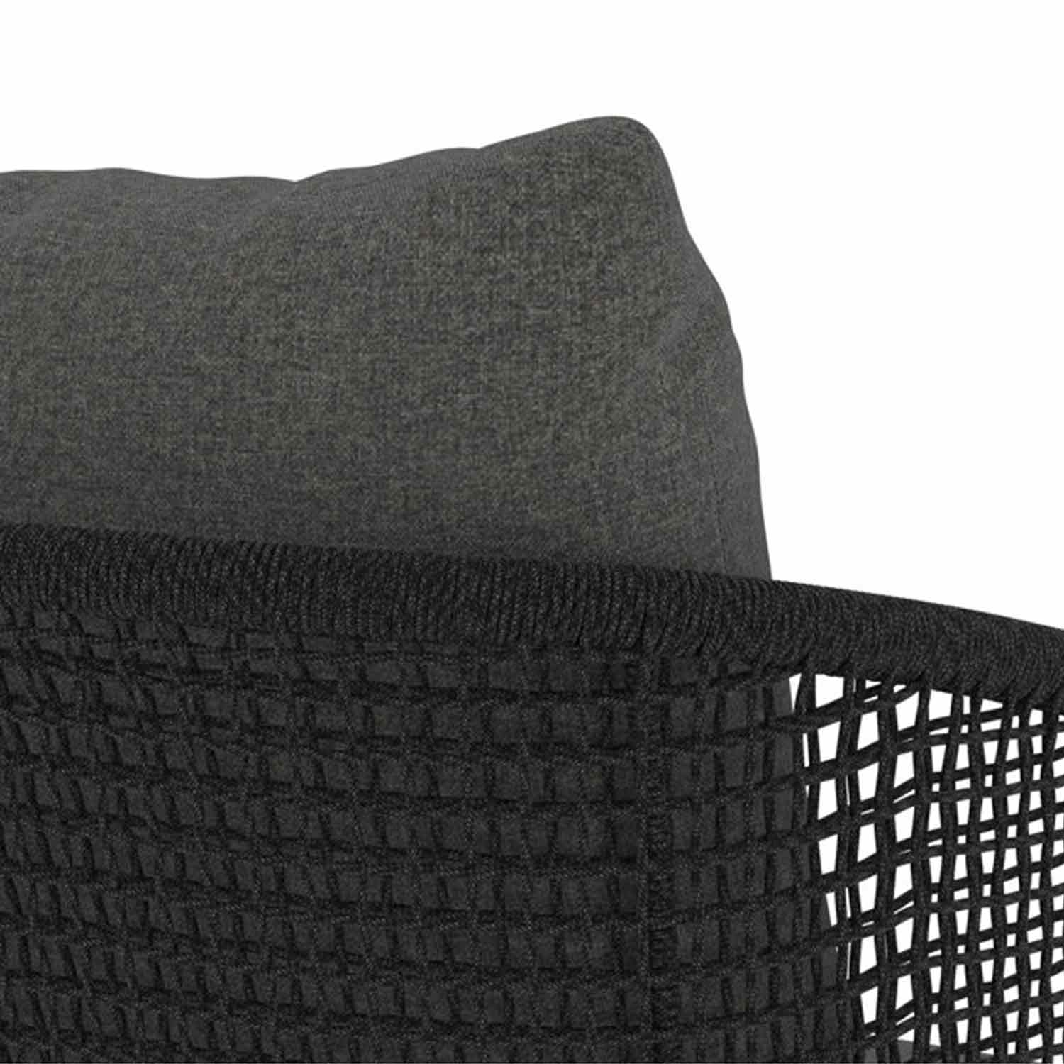 Close-up of a gray fabric cushion nestled into a black woven back panel of an outdoor bar stool, highlighting textured upholstery and grid-like rope weaving in a coastal style.