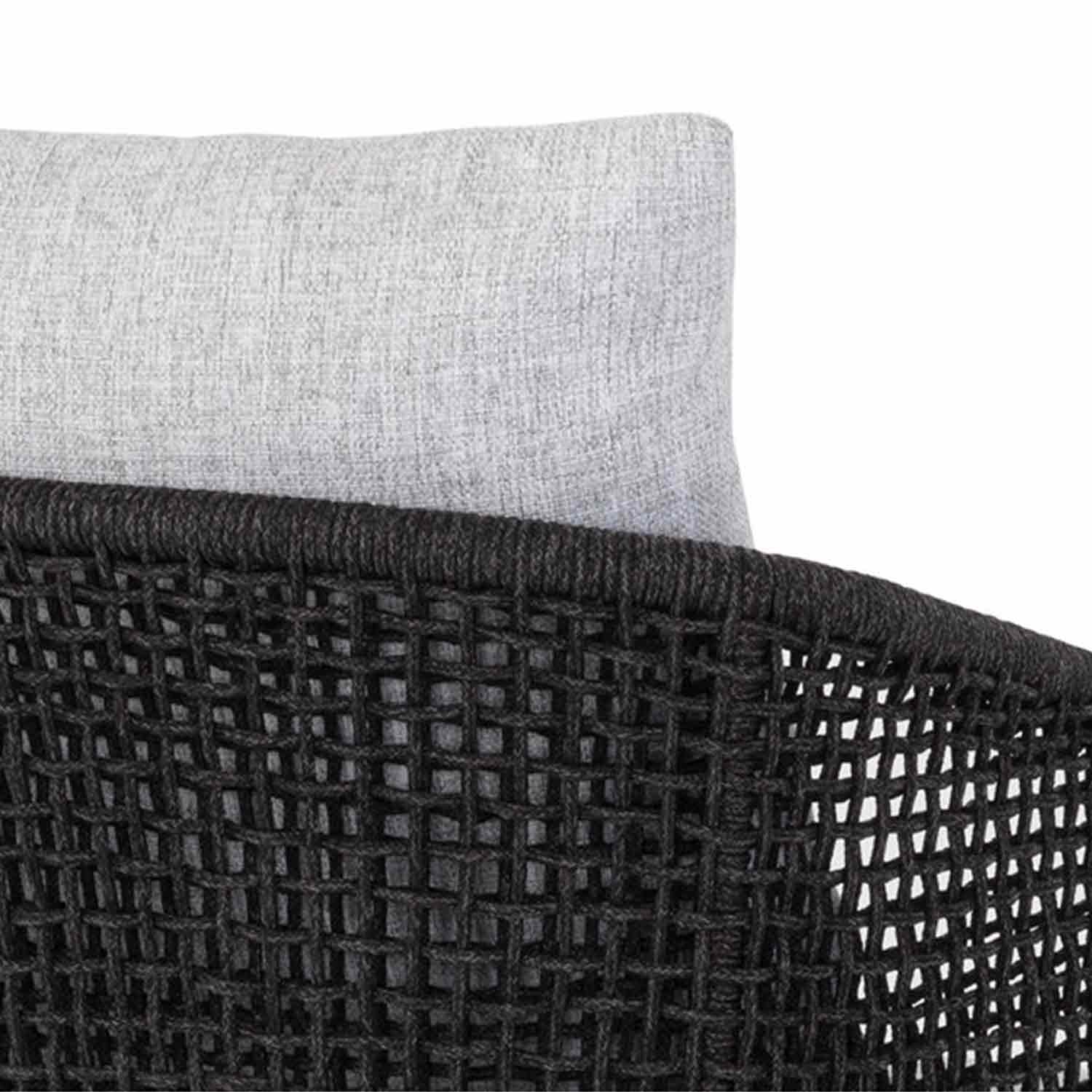 Close-up of an outdoor bar stool's black woven rope back with a light gray fabric cushion visible behind, showing texture and coastal-inspired teak wood design.