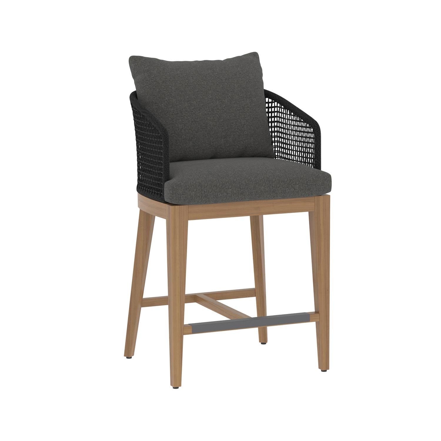 Teak outdoor bar stool with natural wood frame, dark gray fabric seat and back cushions, black woven rope arms and back, and a gray metal footrest for coastal-style counter seating.