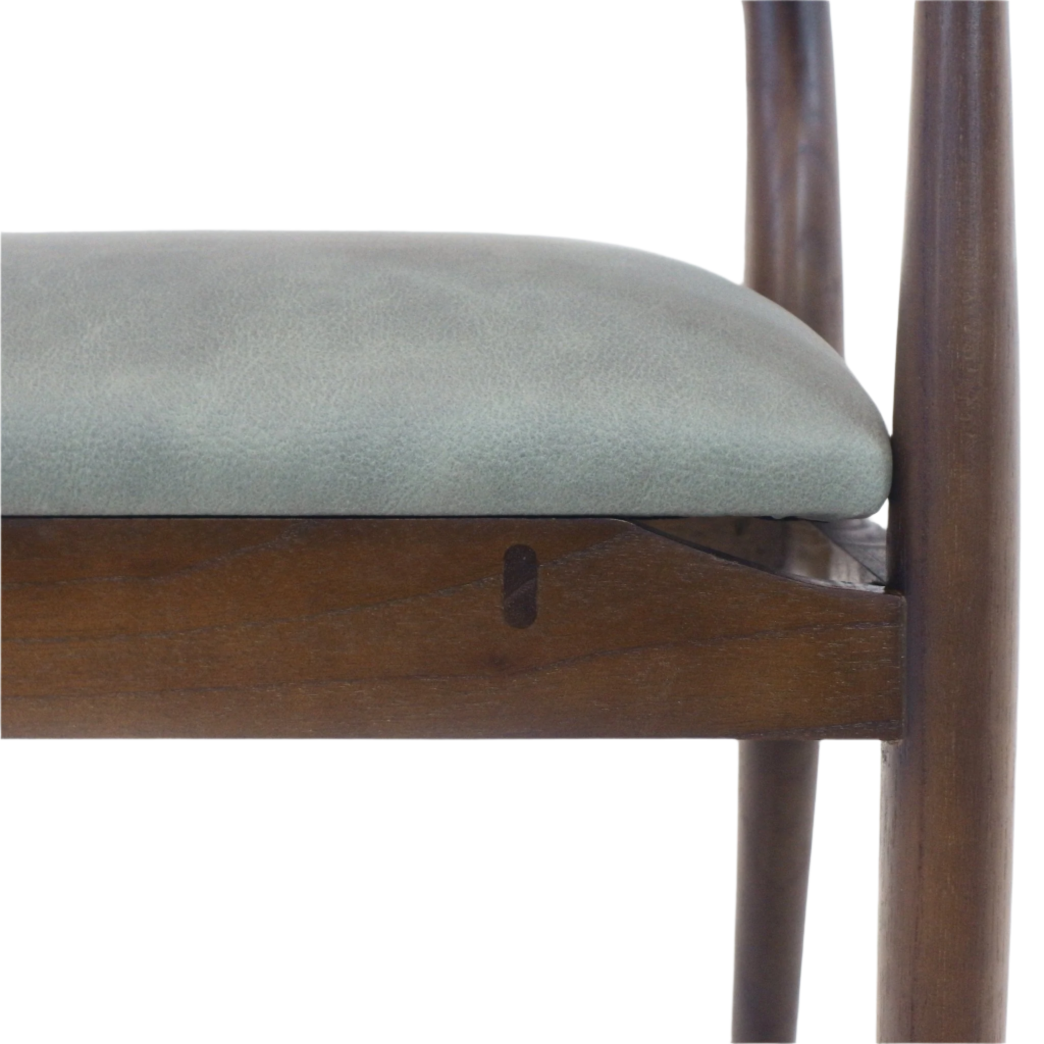 Close-up of a blue leather dining chair seat cushion resting on a natural brown solid wood frame with a tapered leg, showing the seat edge and visible wooden joinery.