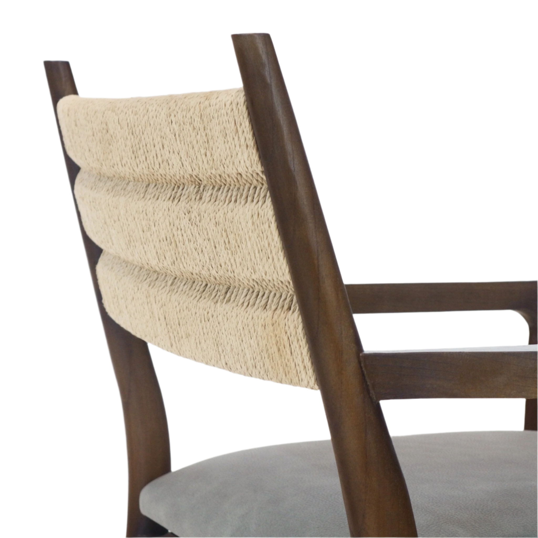 Close-up of a dining chair showing a natural woven rope backrest framed by dark stained solid wood arms and a tan leather seat, reflecting coastal and mid-century modern styling.