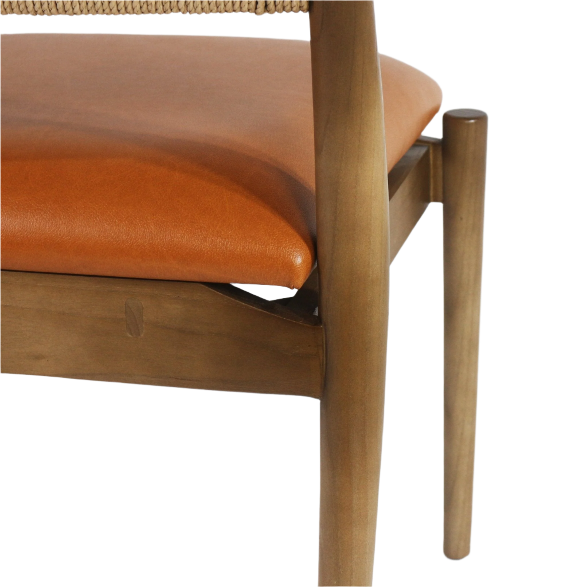 Close-up of a tan faux-leather padded seat on a natural wood frame, showing a tapered round leg, visible joinery and the woven rope back edge in a warm coastal-modern finish.