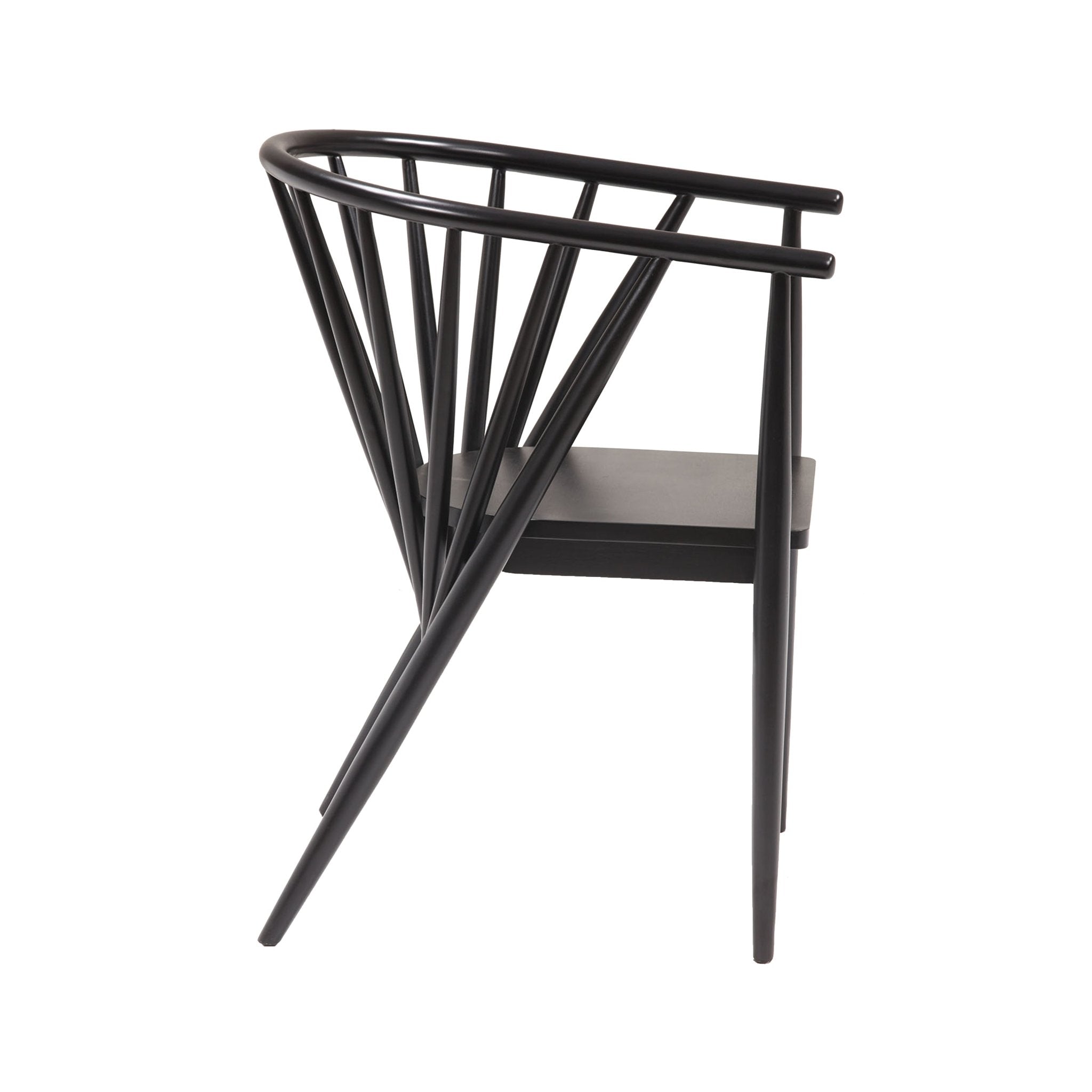 Side view of a mid-century modern solid wood dining chair in black gloss finish with a curved top rail, angled spindle back and tapered legs.