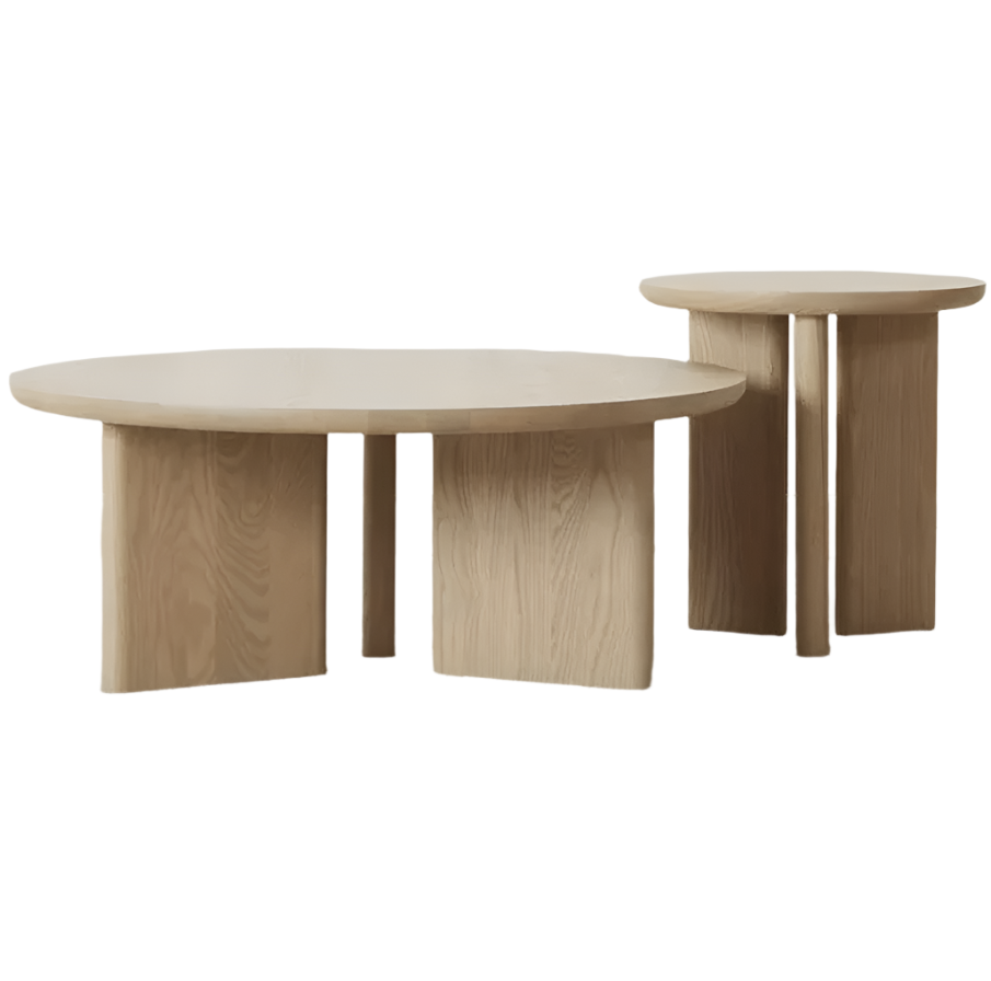Pair of solid oak round coffee tables in a natural oak finish, one low wide table and one taller narrow table, each with thick slab tops and sculptural curved panel legs for a minimalist modern look.