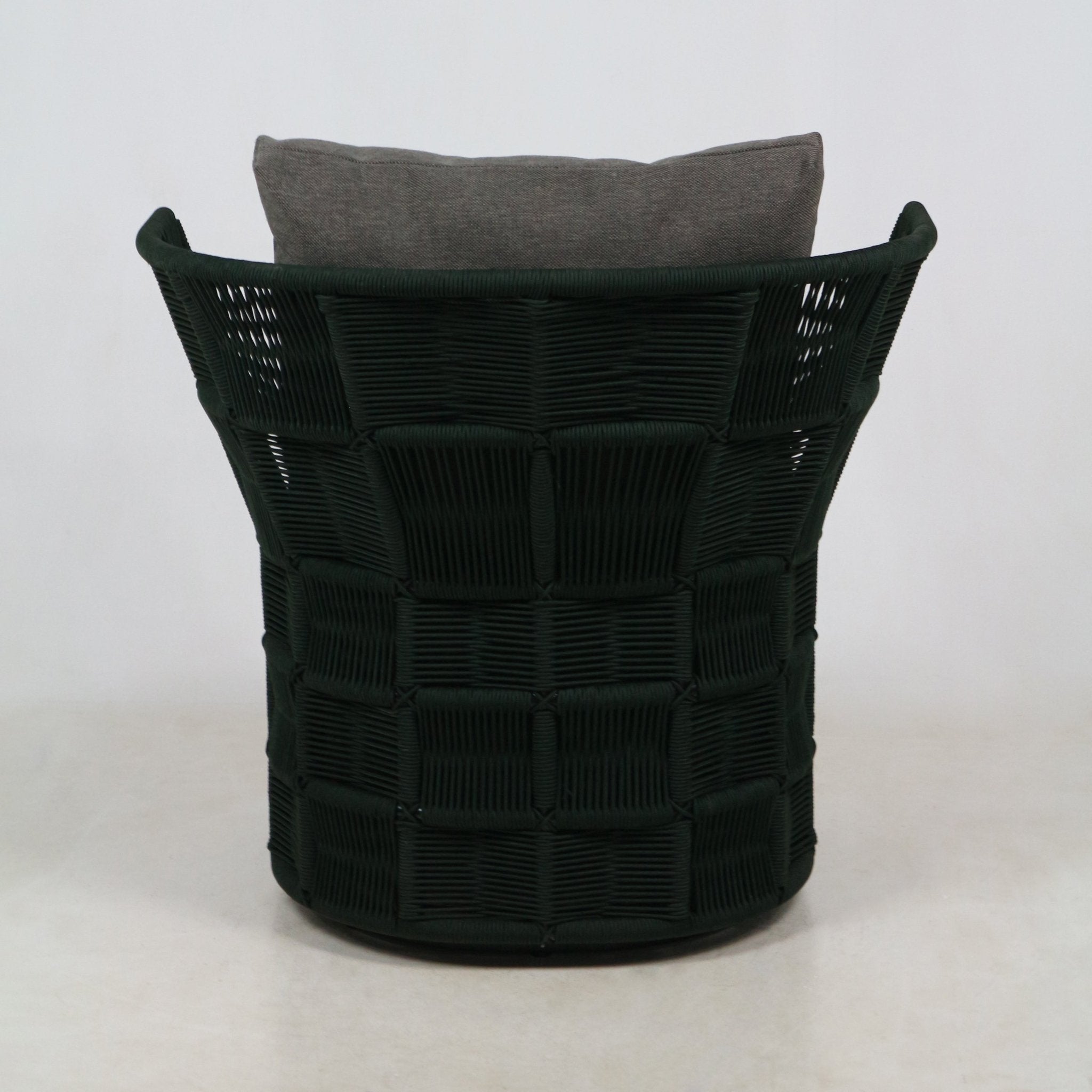 Back view of an outdoor accent chair featuring a dark woven rope grid back and rounded rim, finished with a gray fabric cushion resting against a neutral studio background.