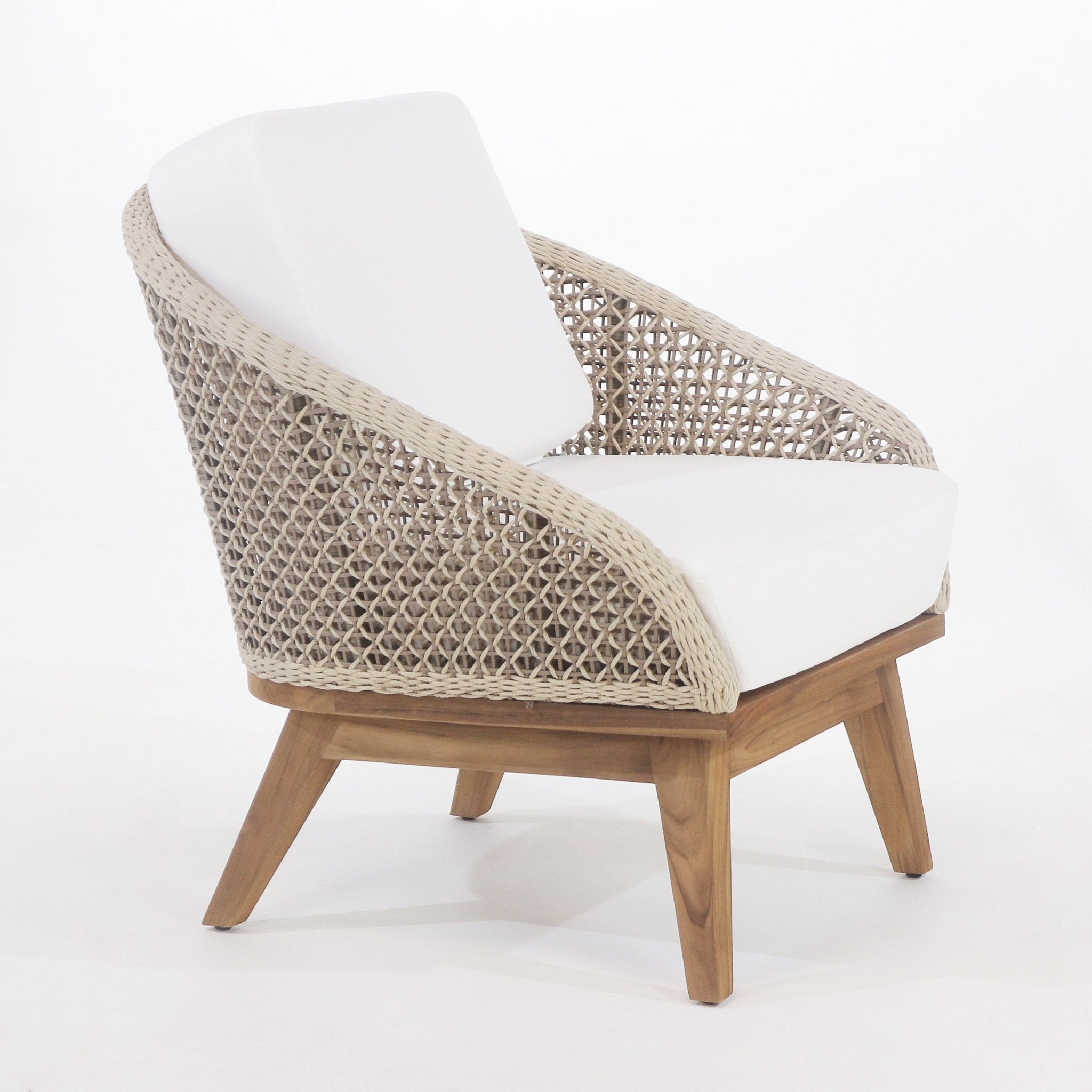 Coastal-style outdoor accent chair with beige rope-woven back and sides, white fabric seat and back cushions, and a warm teak wood frame with angled legs.