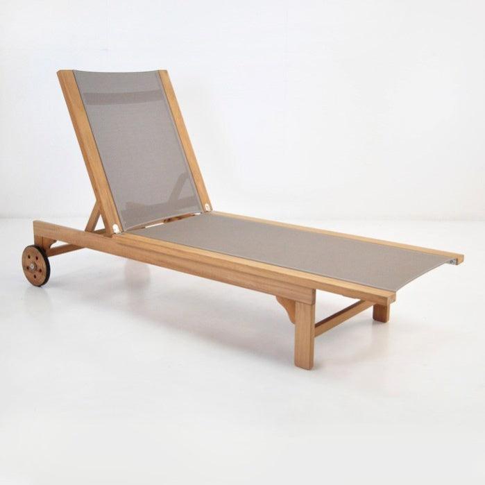 Teak sun lounger with taupe fabric sling, adjustable backrest and wooden wheels on a natural solid wood frame shown on a white background.