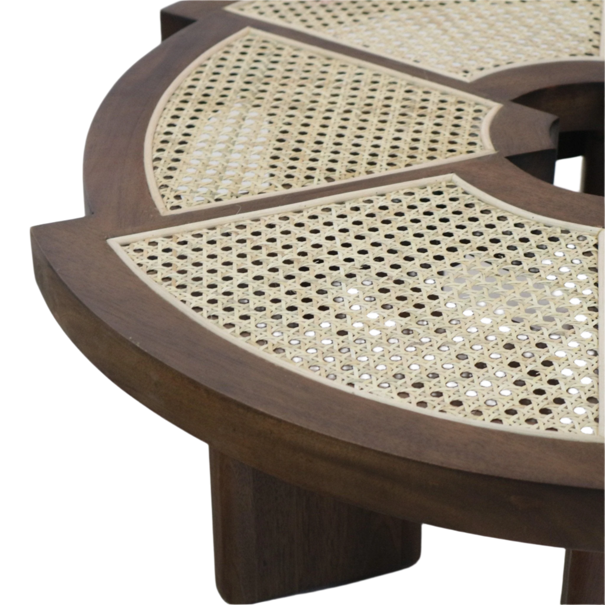Close-up of a round teak coffee table top featuring woven natural cane inlay panels set into a warm brown mid-century modern solid wood frame with a short leg visible.