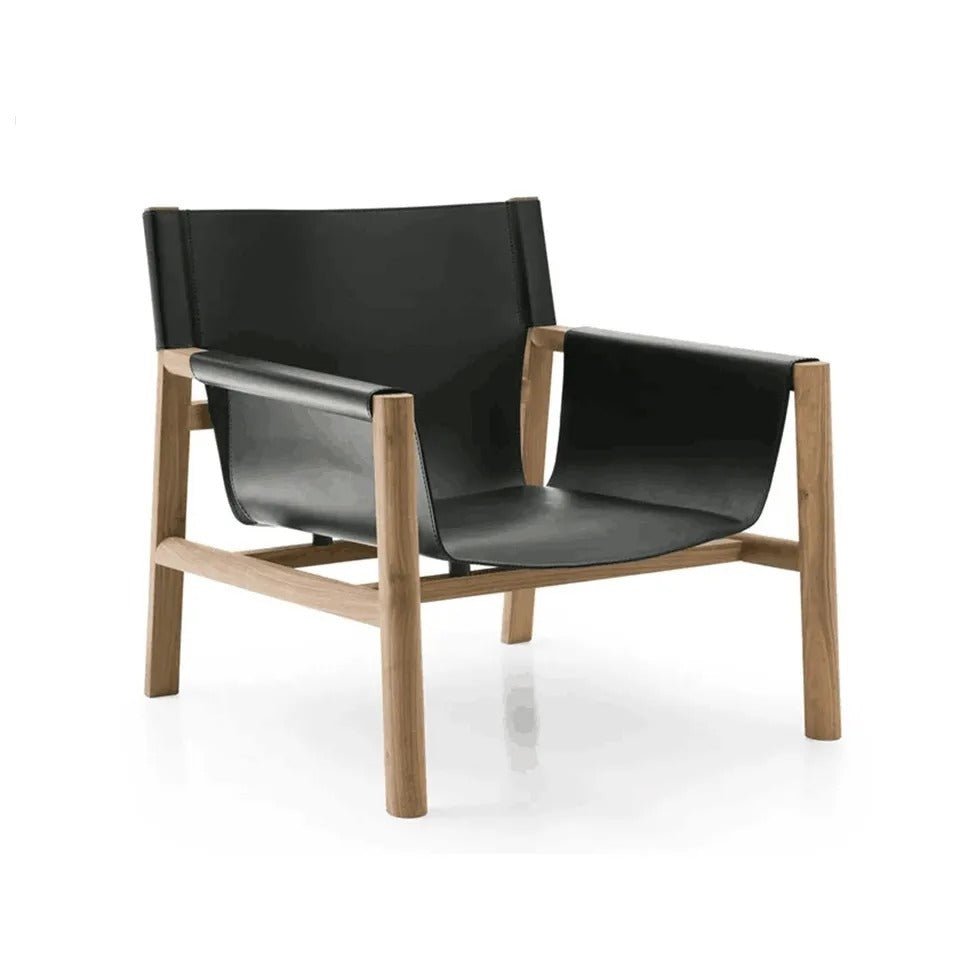 Mid-century modern lounge chair with a natural teak wood frame and black leather sling seat, back and arm slings; low-profile accent chair shown on a white background.