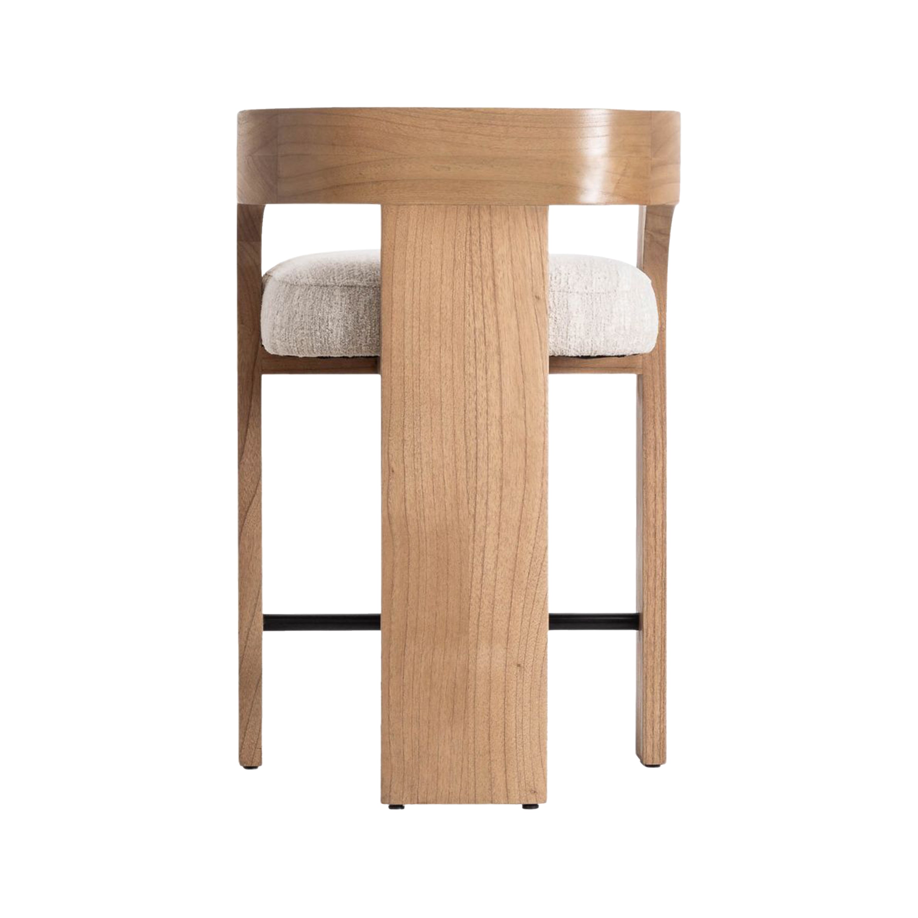 Rear view of a counter-height stool with a curved natural wood U-shaped back and armrests, cream textured fabric seat cushion, and a black metal footrest in a modern Scandinavian style.