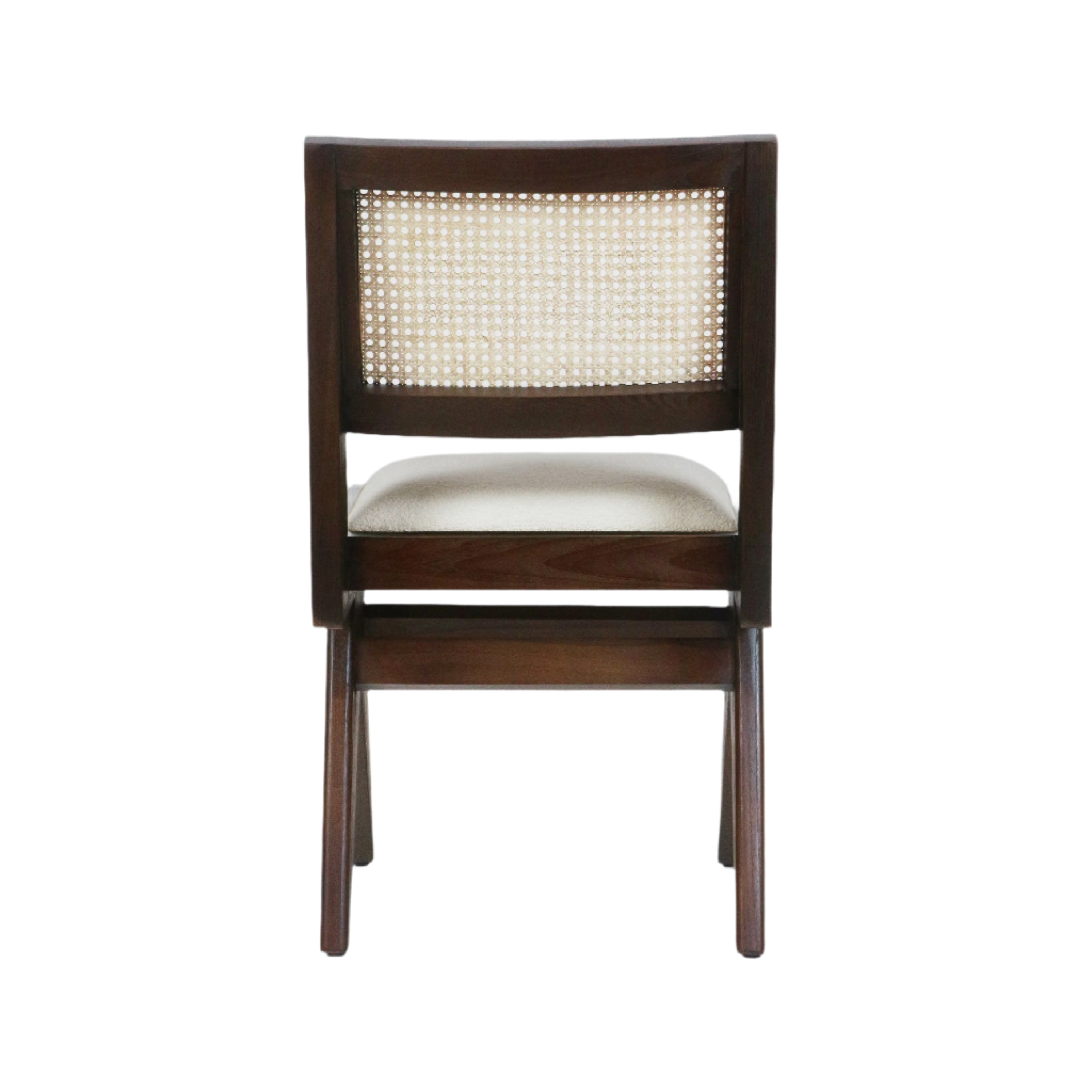 Rear view of an armless mid-century modern dining chair with a dark walnut solid wood frame, woven cane back panel and cream upholstered seat.