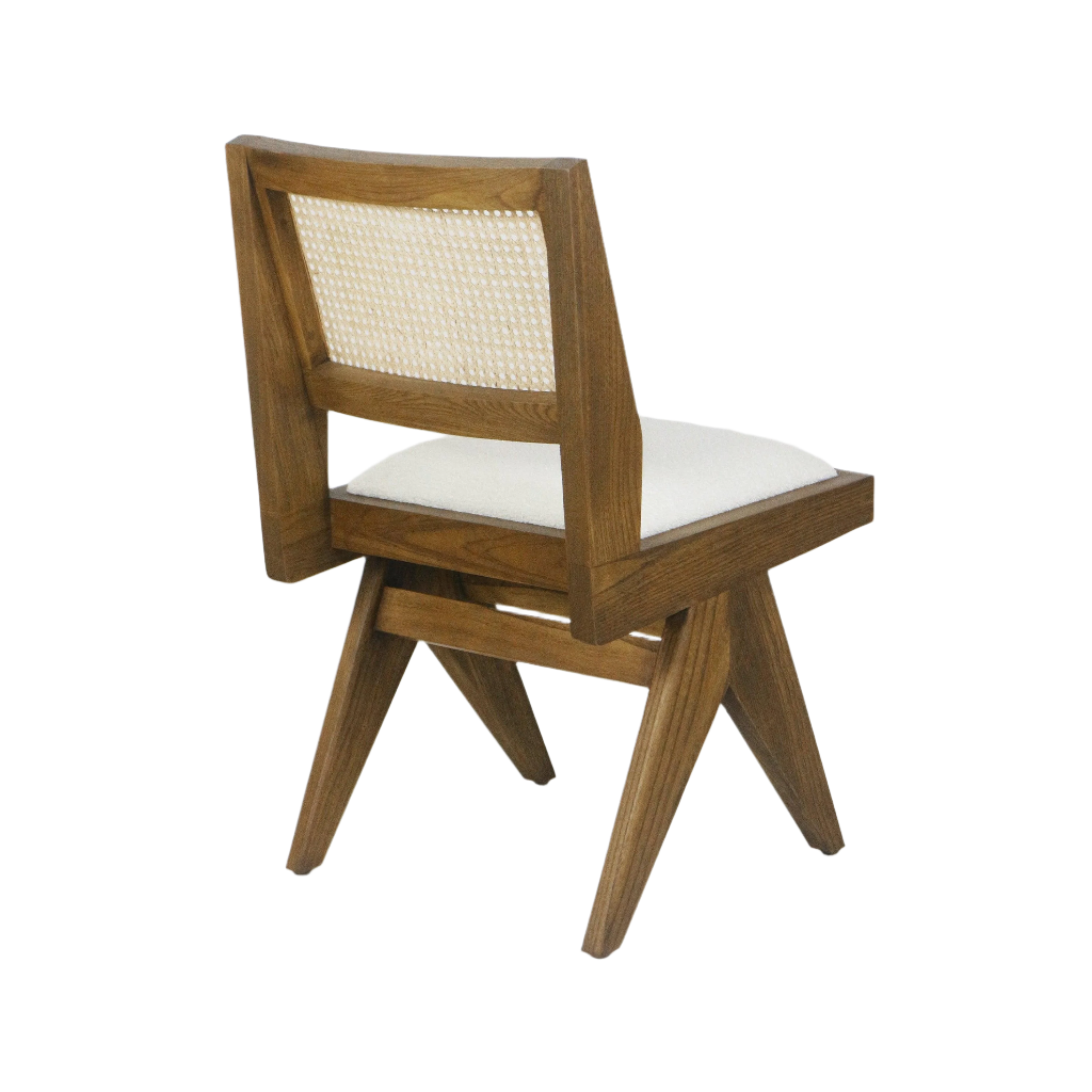 Three-quarter rear view of a mid-century modern armless side chair with medium brown solid ash frame, woven cane back panel and cream upholstered seat.