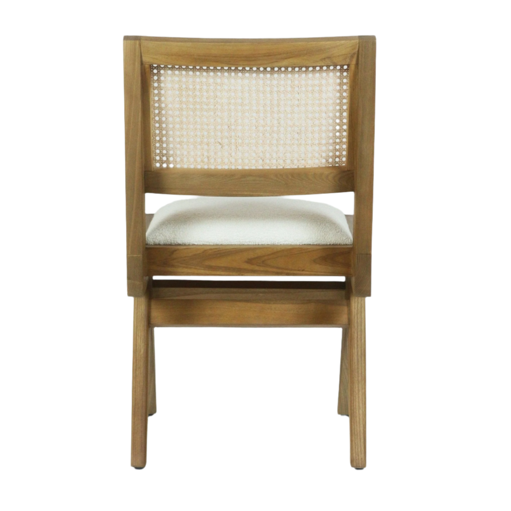 Rear view of an armless side chair in natural ash wood with a woven cane back panel and a cream boucle upholstered seat.