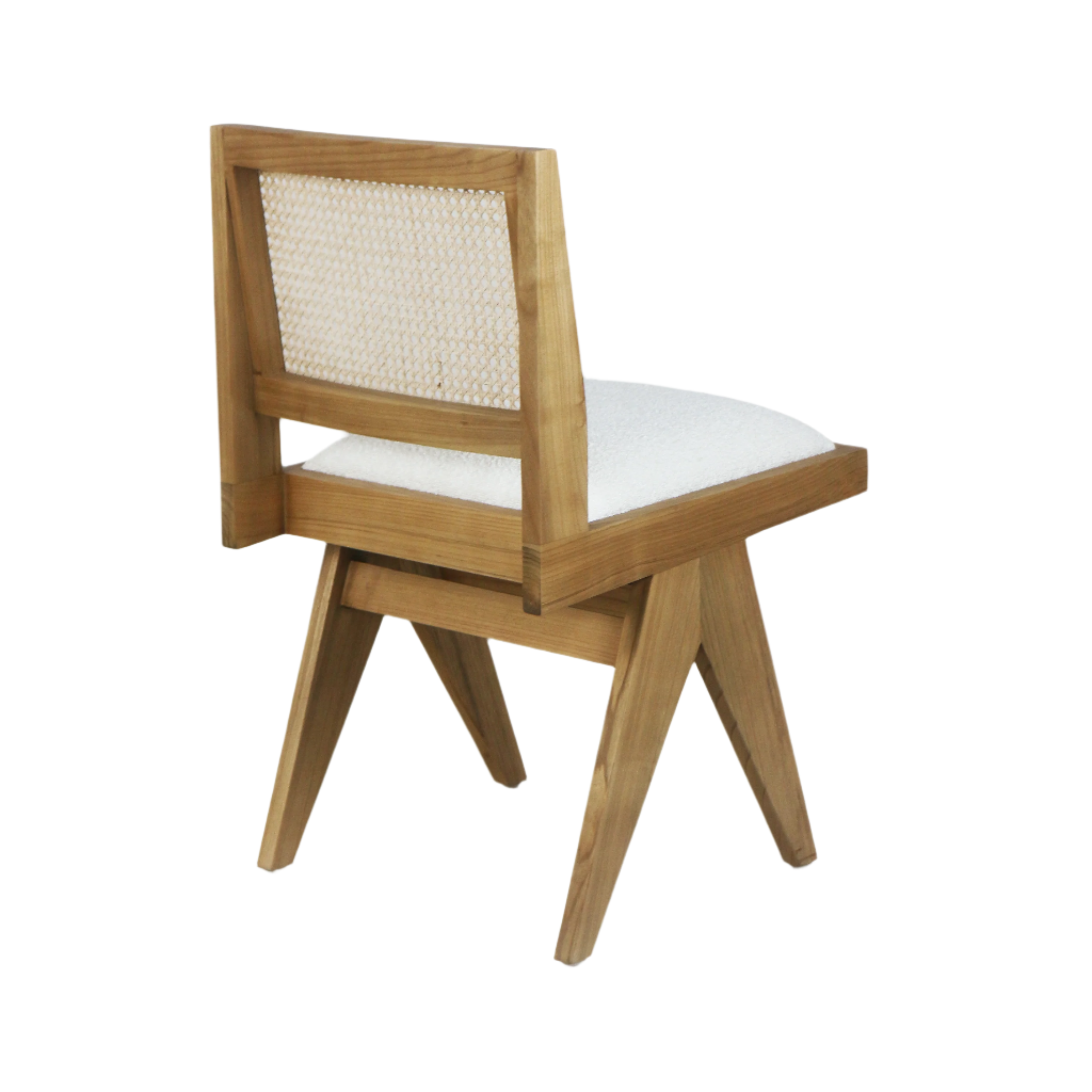 Upholstered armless side chair in natural blonde solid wood with a woven cane back and cream boucle seat, shown from a rear three-quarter view highlighting its angled mid-century legs.