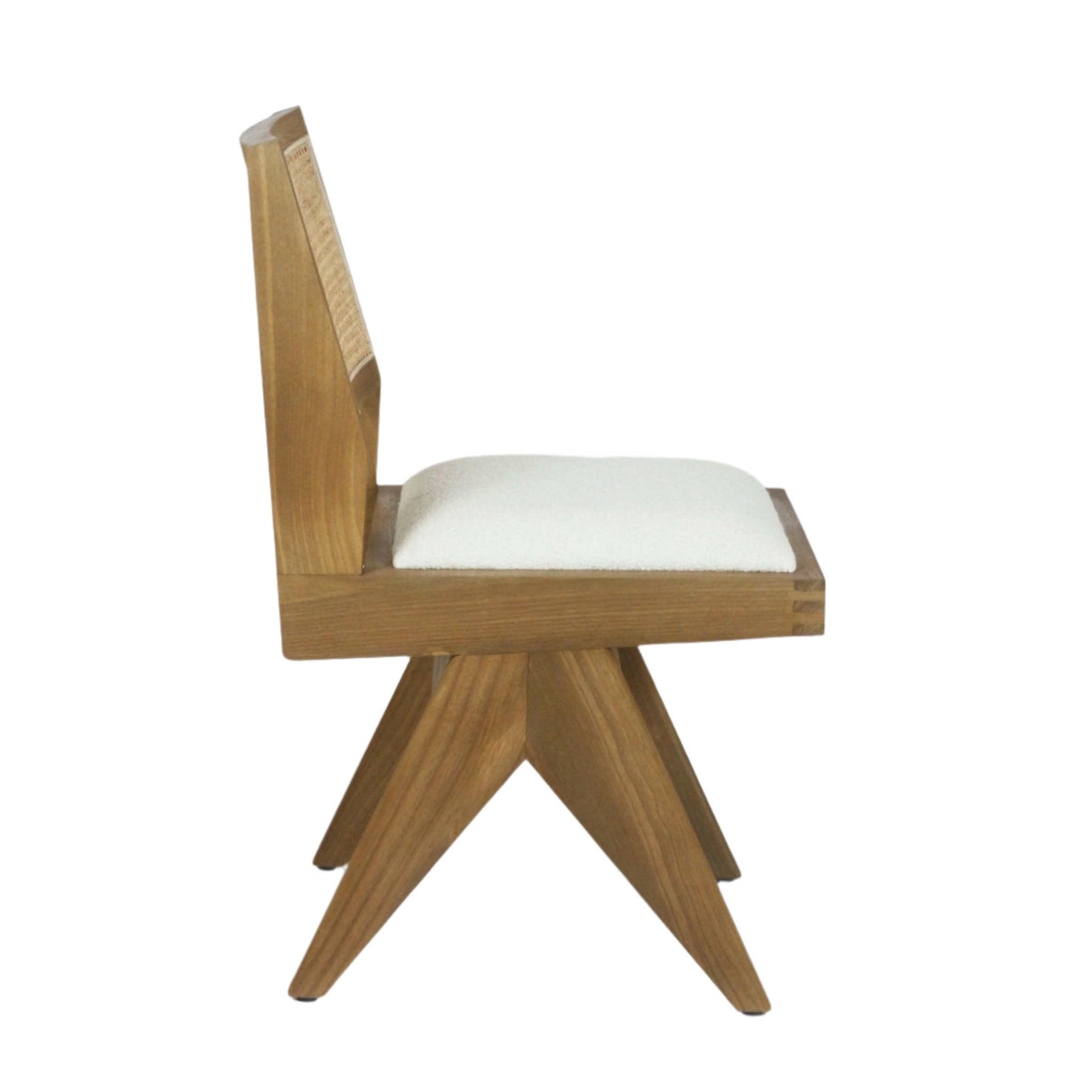 Side view of an armless dining chair with a natural ash wood frame, woven cane back panel and cream upholstered seat resting on a sculptural four-point star base in mid-century modern style.