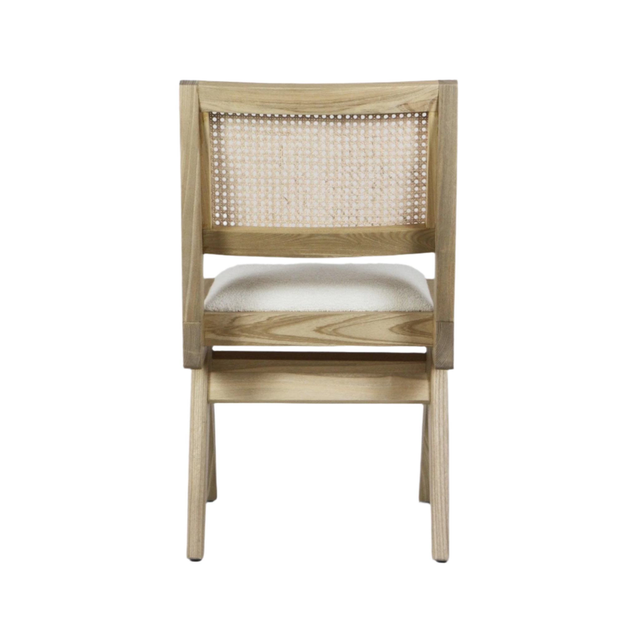 Rear view of an armless solid ash dining chair with woven cane back and cream boucle upholstered seat, showing light natural wood grain and tapered legs.