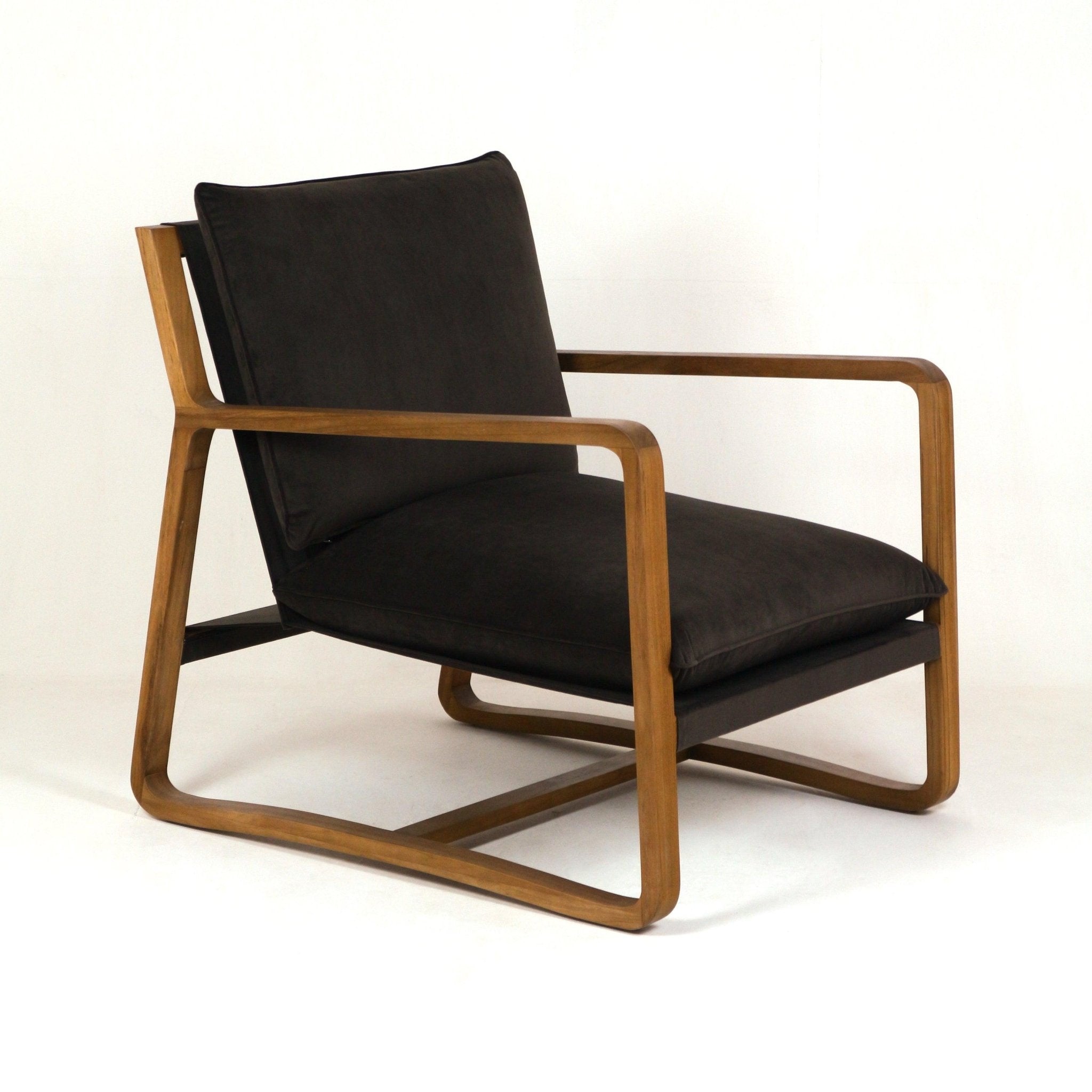 Mid-century modern lounge chair with a curved oak frame and armrests, featuring deep olive-green velvet seat and back cushions on a sled-style base.
