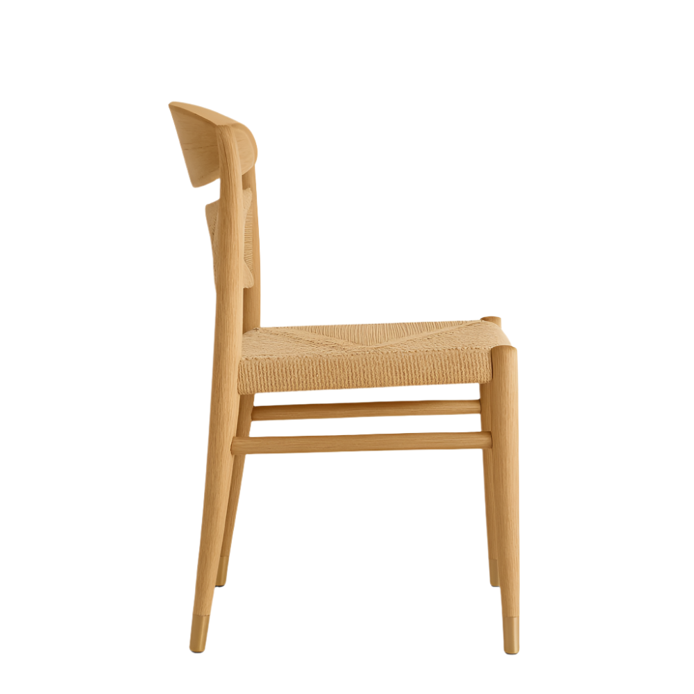 Side view of an armless mid-century modern dining chair in natural solid wood with a woven natural-fiber seat, curved low back and tapered legs with brass-tone caps on a white background.