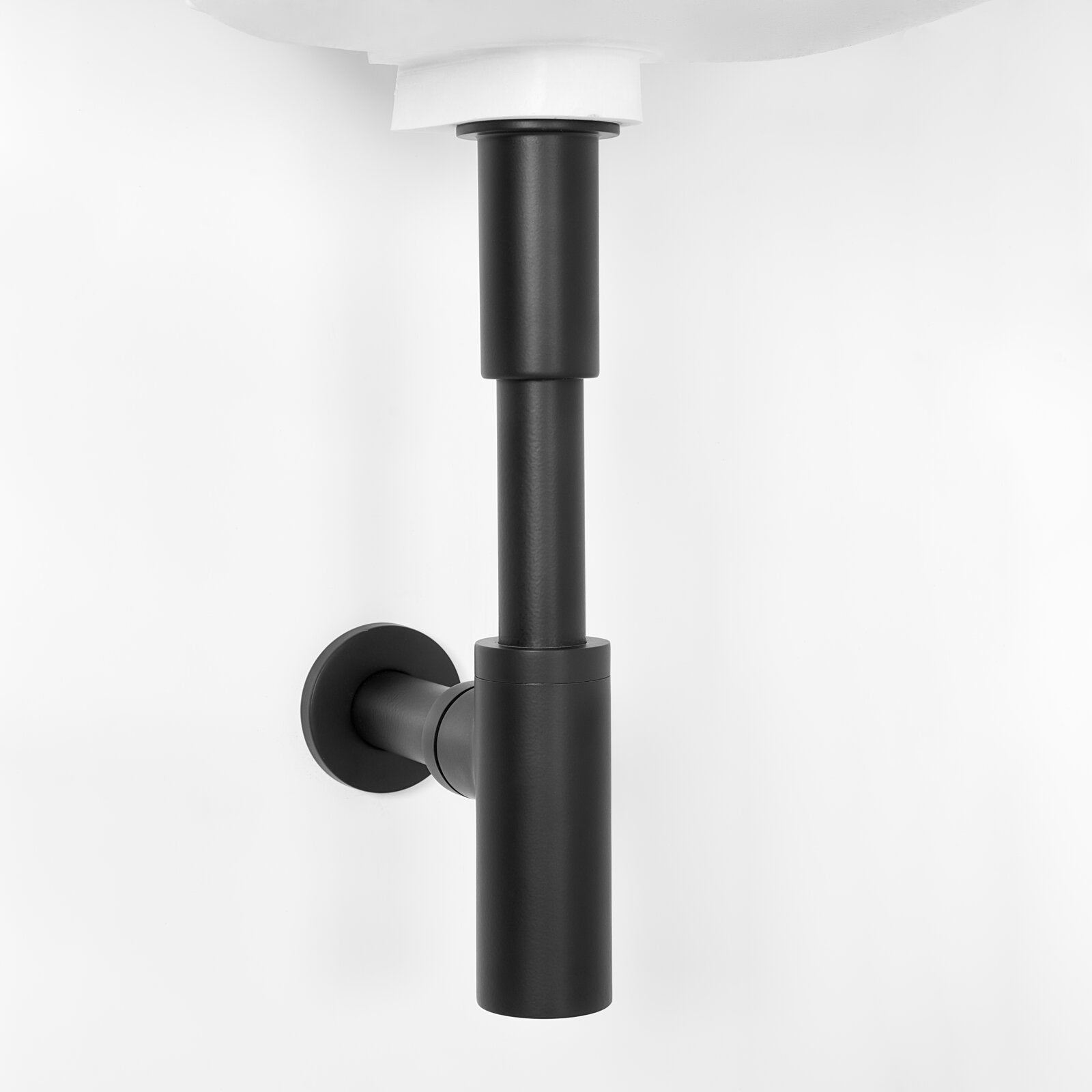Matte black cylindrical P‑trap and round wall flange mounted beneath a white ceramic sink, shown against a clean white background as a modern bathroom vanity plumbing detail.