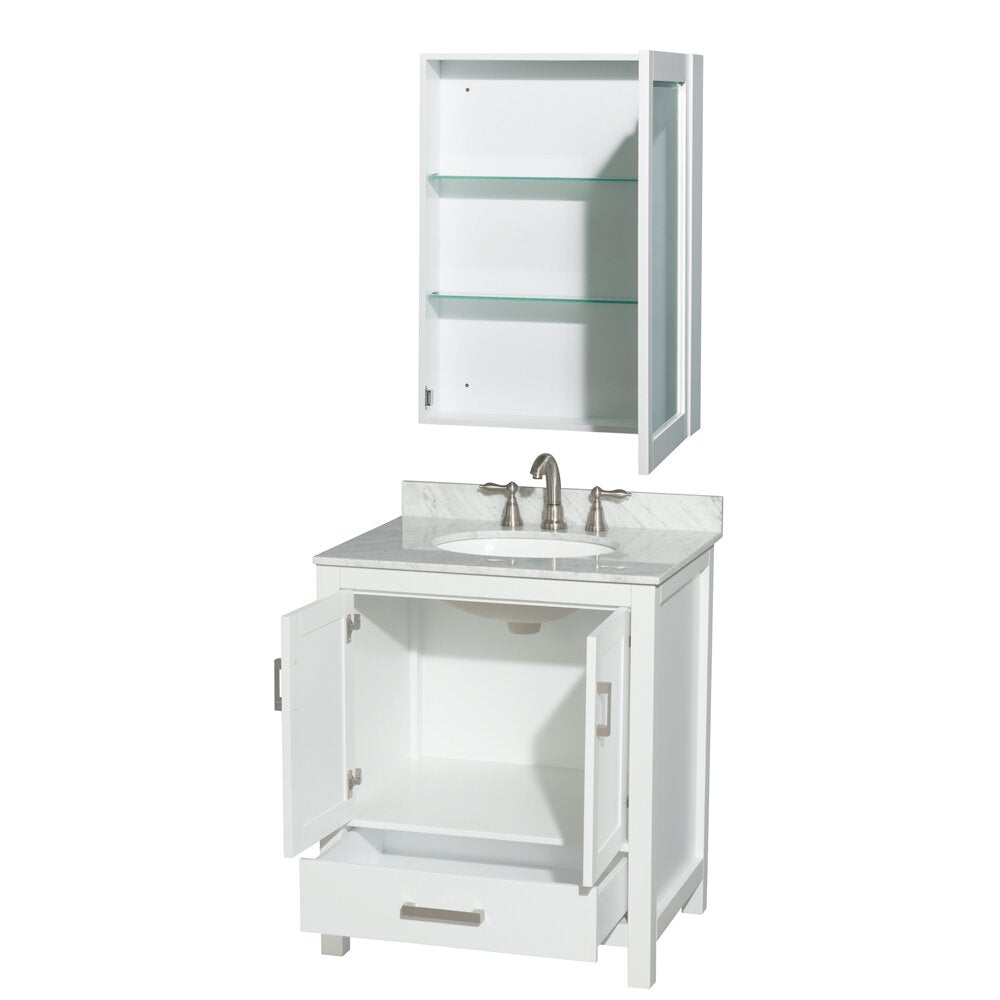 White solid wood 30-inch single-sink bathroom vanity with gray stone top and undermount ceramic sink, brushed nickel faucet, open cabinet and lower drawer, shown with matching wall medicine cabinet with glass shelves.